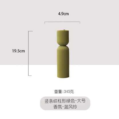 Handmade scented candles with striped columns. White and green decoration. Blue wind chimes scented candles accompanied the cere