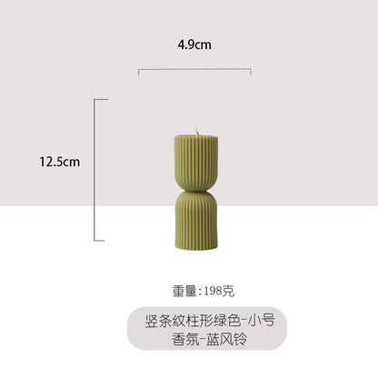 Handmade scented candles with striped columns. White and green decoration. Blue wind chimes scented candles accompanied the cere