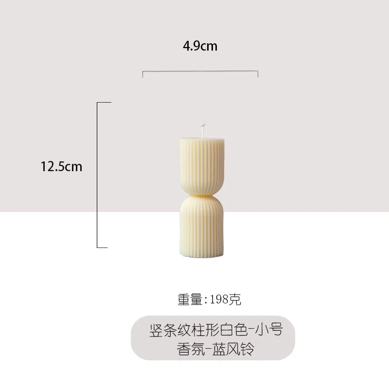 Handmade scented candles with striped columns. White and green decoration. Blue wind chimes scented candles accompanied the cere