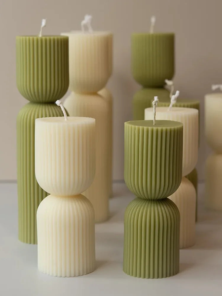 Handmade scented candles with striped columns. White and green decoration. Blue wind chimes scented candles accompanied the cere