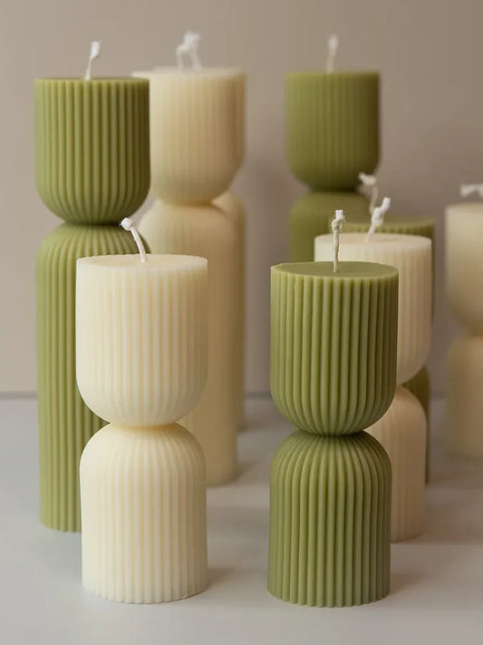 Handmade scented candles with striped columns. White and green decoration. Blue wind chimes scented candles accompanied the cere